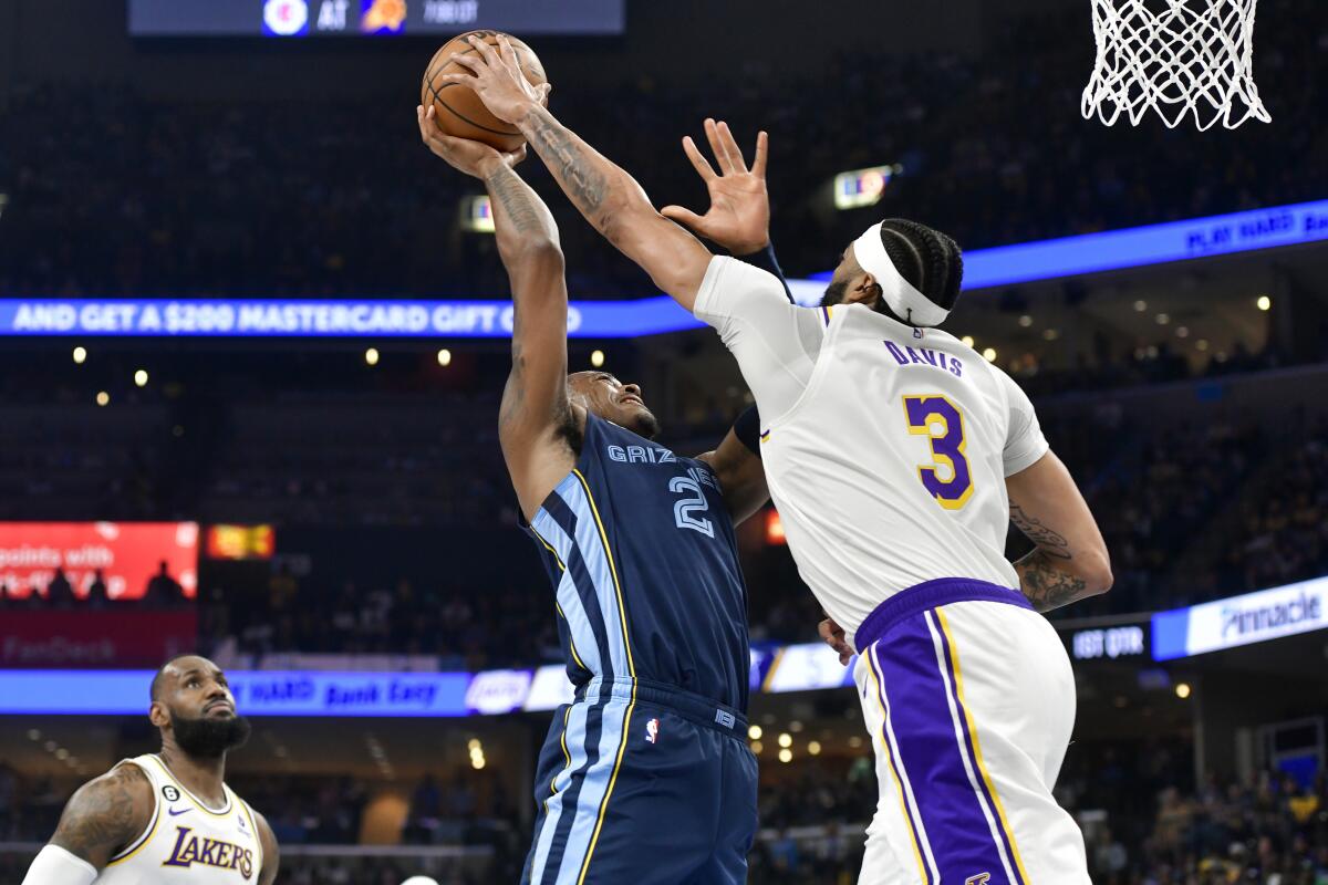 Grizzlies forward Xavier Tillman has his shot in the lane blocked by Lakers forward Anthony Davis.
