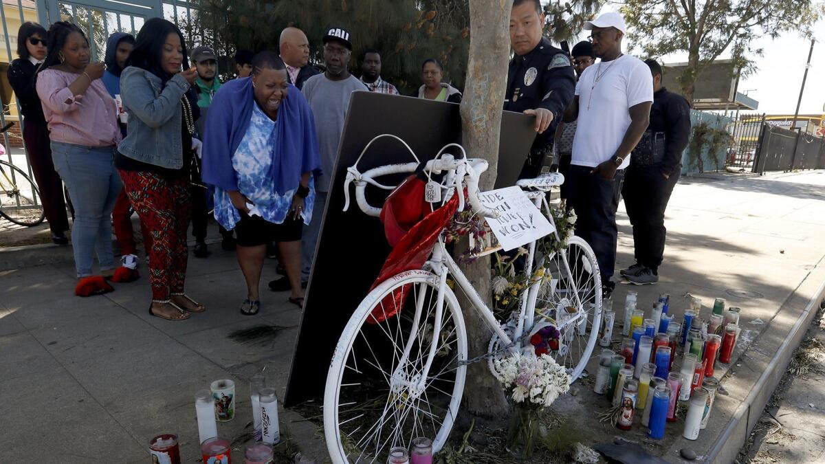 Beverly Owens, the mother of bicyclist Frederick Frazier, is overcome with emotion as she visits the site of the hit-and-run incident that claimed the life of her 22-year-old son.