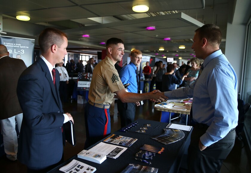 Job seekers meet with a Sacramento Police Department recruiter during a job fair in San Francisco last month.