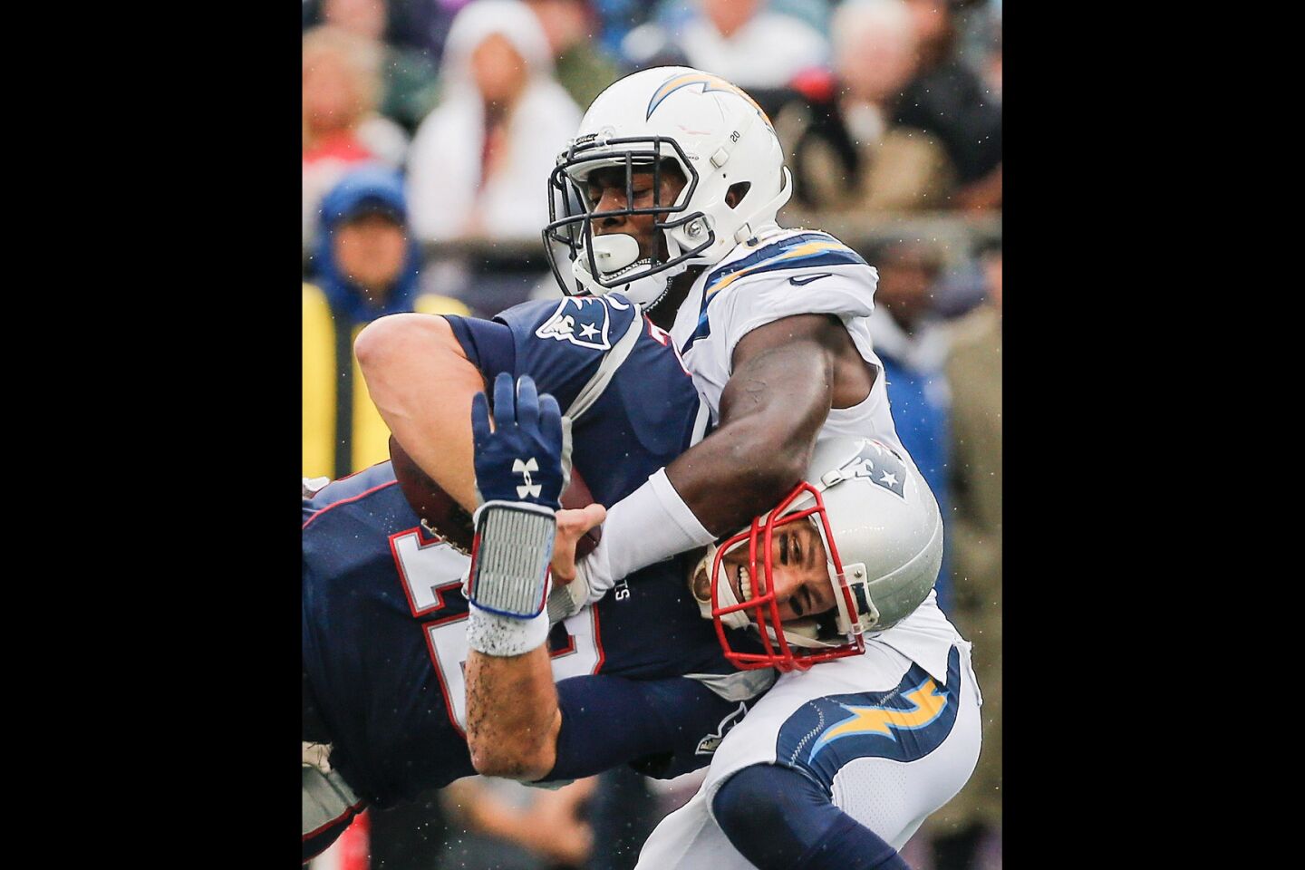 The Chargers' Desmond King tackles the Patriots' Tom Brady during the third quarter.