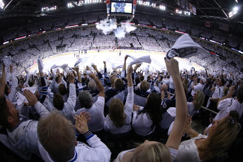 Jets fans create a whiteout by waving towels during the first playoff game in Winnipeg in 19 years on Monday night at the MTS Centre.