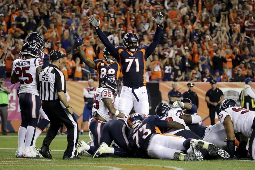 Broncos offensive tackle Donald Stephenson (71) celebrates a touchdown run by teammate Andy Janovich against the Houston Texans during the second half on Oct. 24.