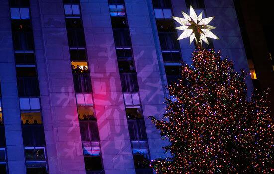 Spectators look down on the Rockefeller Center Christmas ceremony from adjacent buildings.