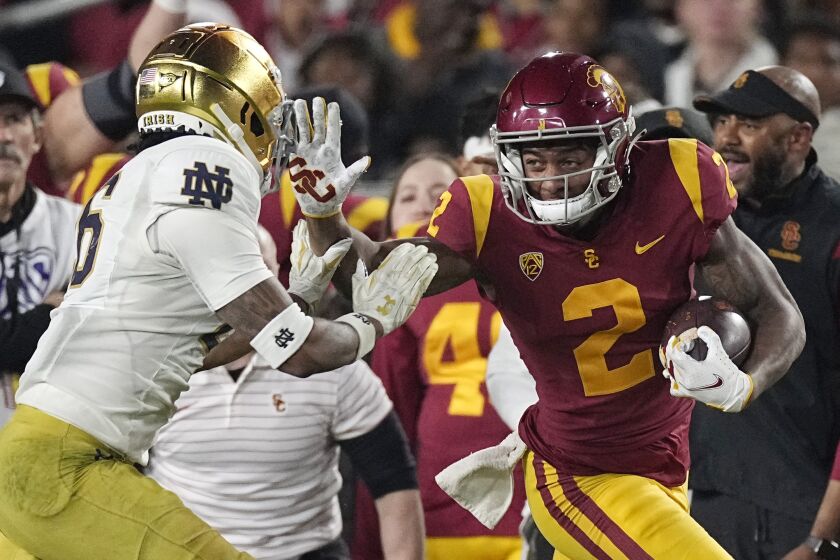 Southern California wide receiver Brenden Rice, right, fends off Notre Dame cornerback Clarence Lewis during the second half of an NCAA college football game Saturday, Nov. 26, 2022, in Los Angeles. (AP Photo/Mark J. Terrill)