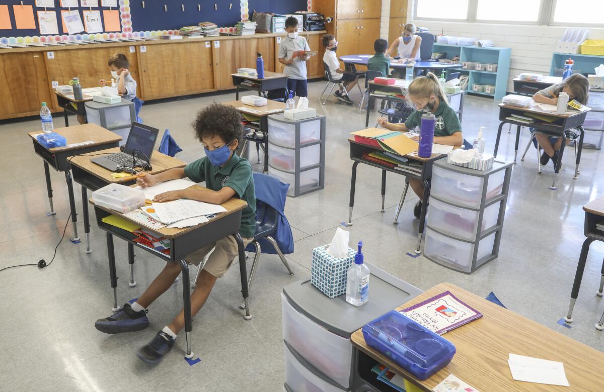 Second grade students study in their classroom at St. Columba Catholic School on Friday