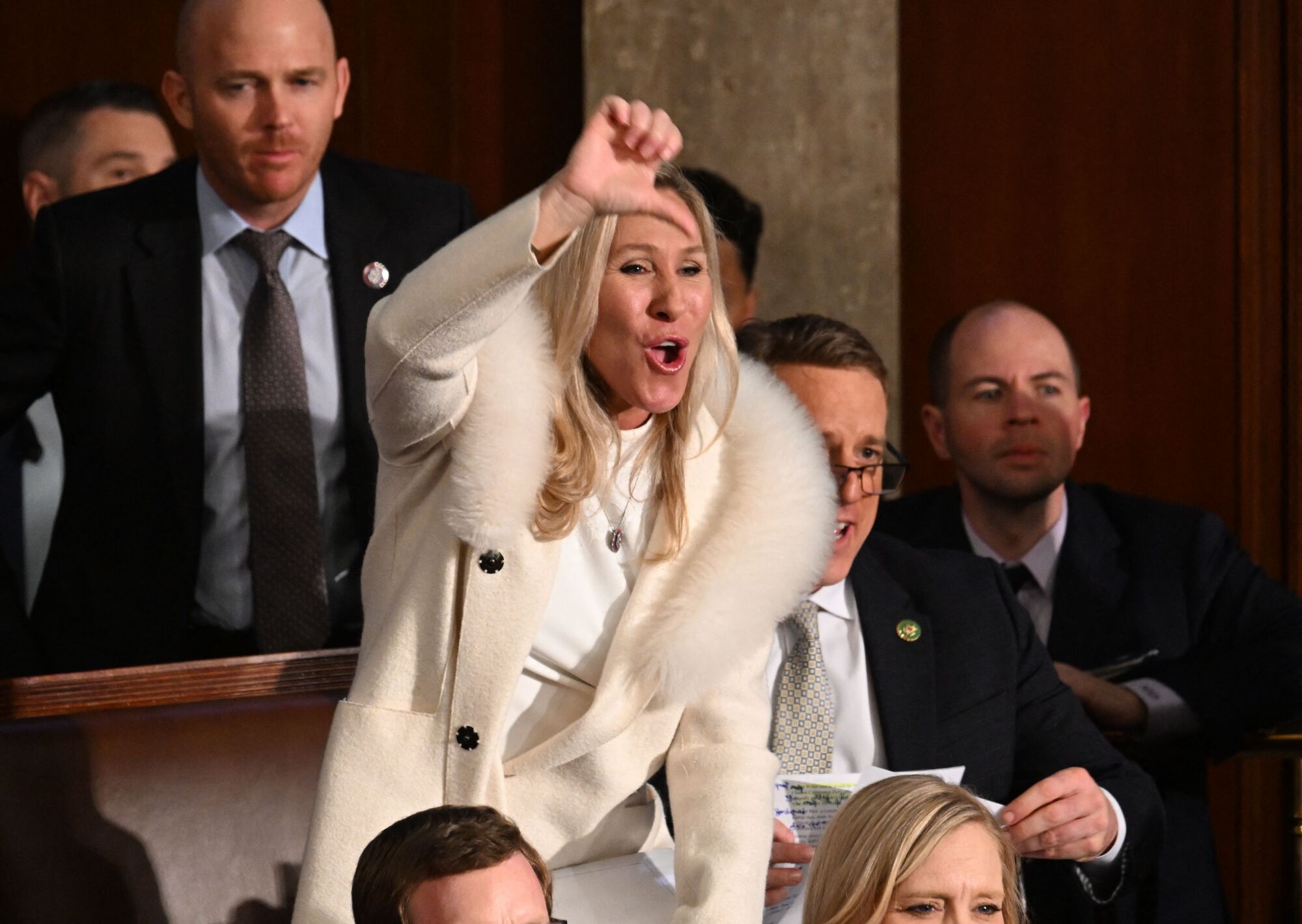 Rep. Marjorie Taylor Greene (R-GA) gives a thumb down as President Joe Biden delivers the State of the Union address 