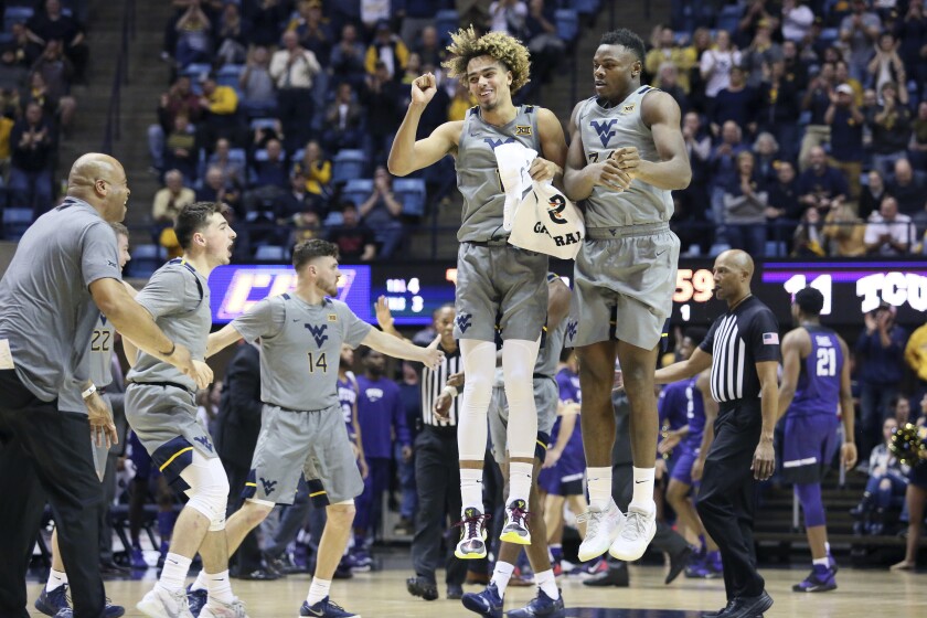 West Virginia forwards Emmitt Matthews Jr. (11) and Oscar Tshiebwe (34) celebrate after a score during the first half of the team's NCAA college basketball game against TCU on Tuesday, Jan. 14, 2020, in Morgantown, W.Va. (AP Photo/Kathleen Batten)