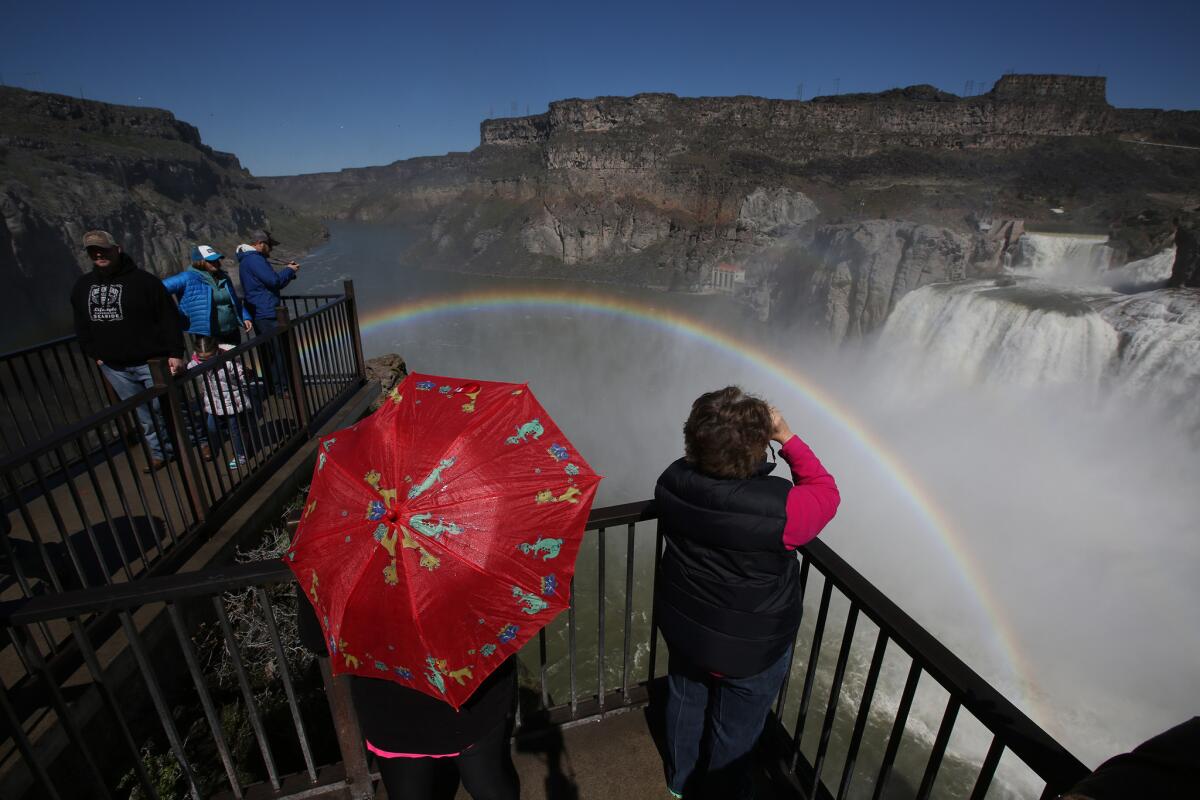 Visitors view a rainbow in the mist from Shoshone Falls on the Snake River.