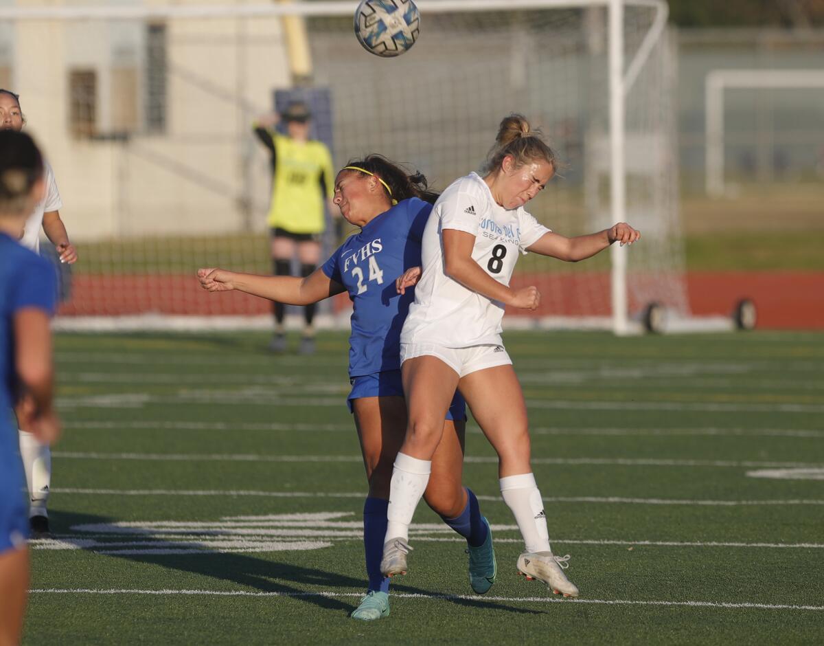 Corona del Mar's Isabelle Almarez (8) and Angela Maytorena (24) battle for control.