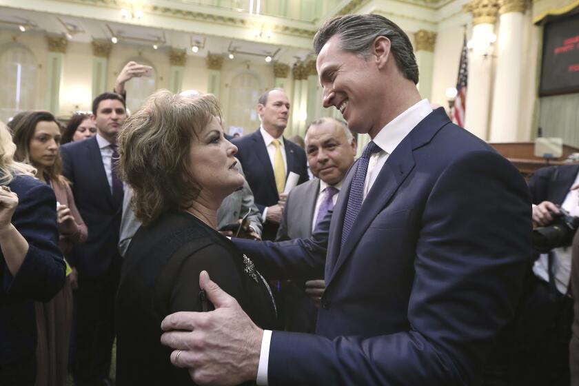 California Gov. Gavin Newsom talks with Senate Republican Leader Shannon Grove, of Bakersfield, after giving his first state of the state address to a joint session of the legislature at the Capitol Tuesday, Feb. 12, 2019, in Sacramento, Calif. (AP Photo/Rich Pedroncelli)