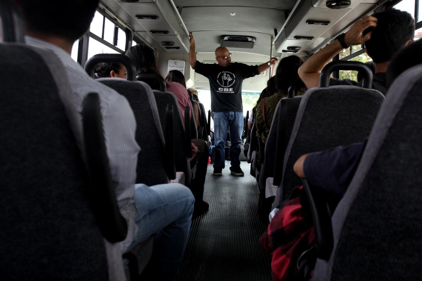 Roberto Cabrales, an organizer with Communities for a Better Environment, briefs sightseers on a "toxic tour" starting in Huntington Park. The half-day excursions were begun in 1994 as a way to show government officials the consequences of their decisions on low-income and predominantly Latino communities.