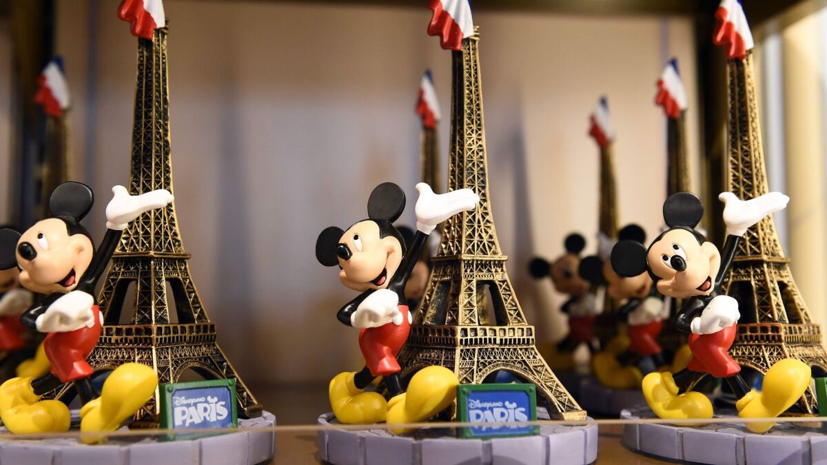 Souvenirs are on display at a Disney store at Disneyland Paris in Marne-la-Vallee. Walt Disney Co. has announced plans to take over Euro Disney and invest $1.6 billion to make improvements and reduce debt.