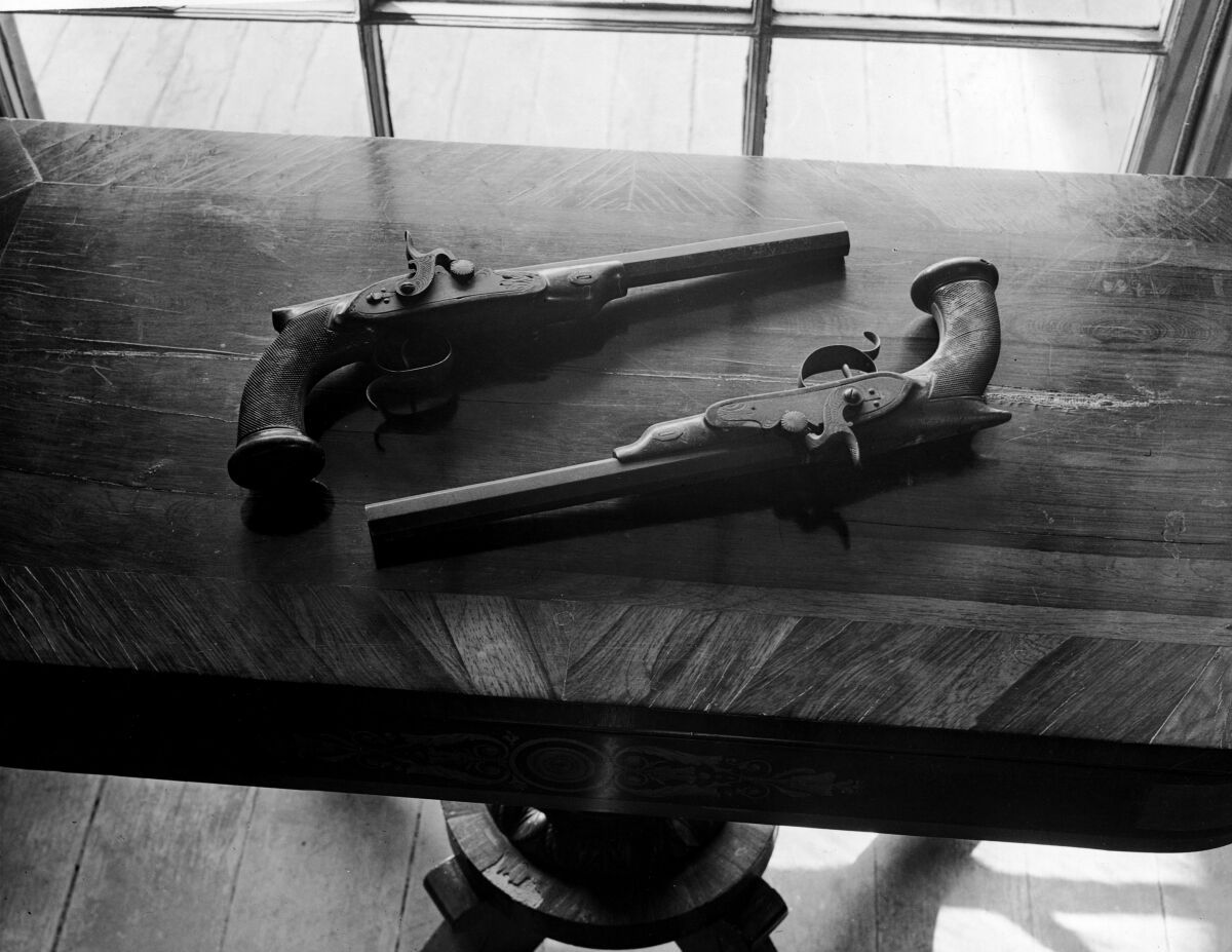 Two old pistols on a table