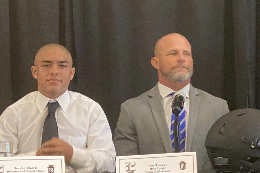 Houston Thomas (left) with his father, Servite coach Troy Thomas, last August during Trinity League media day.