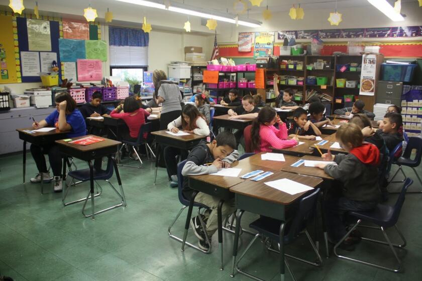 Fifth-graders do class work at a Kansas City elementary school that was part of a lawsuit filed to seek more education funding from the Legislature.