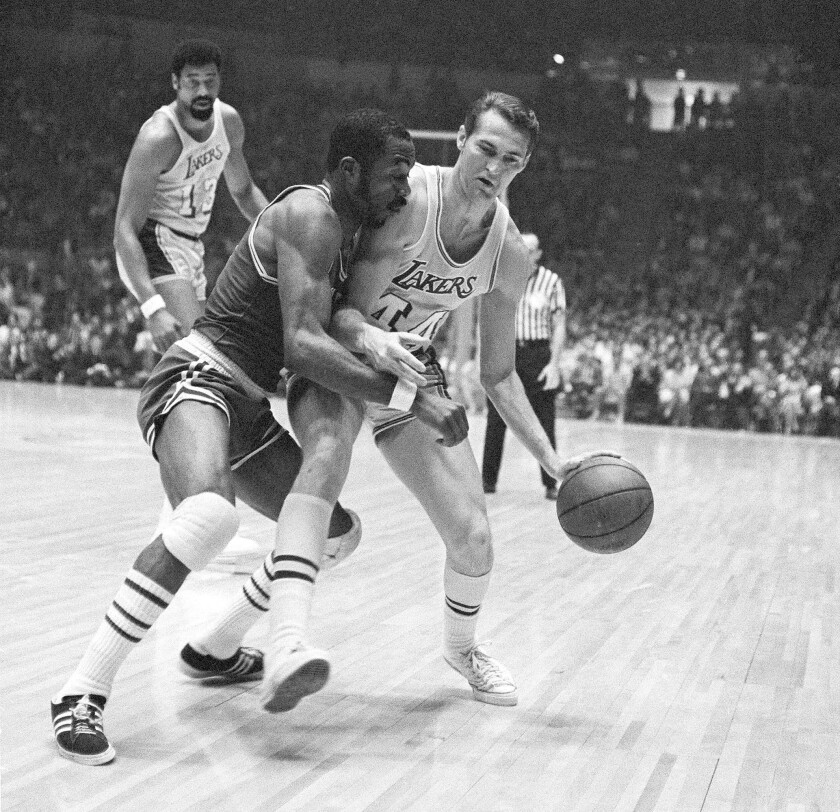 Jerry West, guarded by Boston's Emmette Bryant, relegated Wilt Chamberlain to a background player