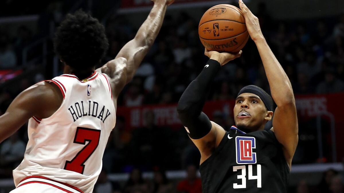 The Clippers' Tobias Harris shoots over Bulls guard Justin Holiday in a game last month.