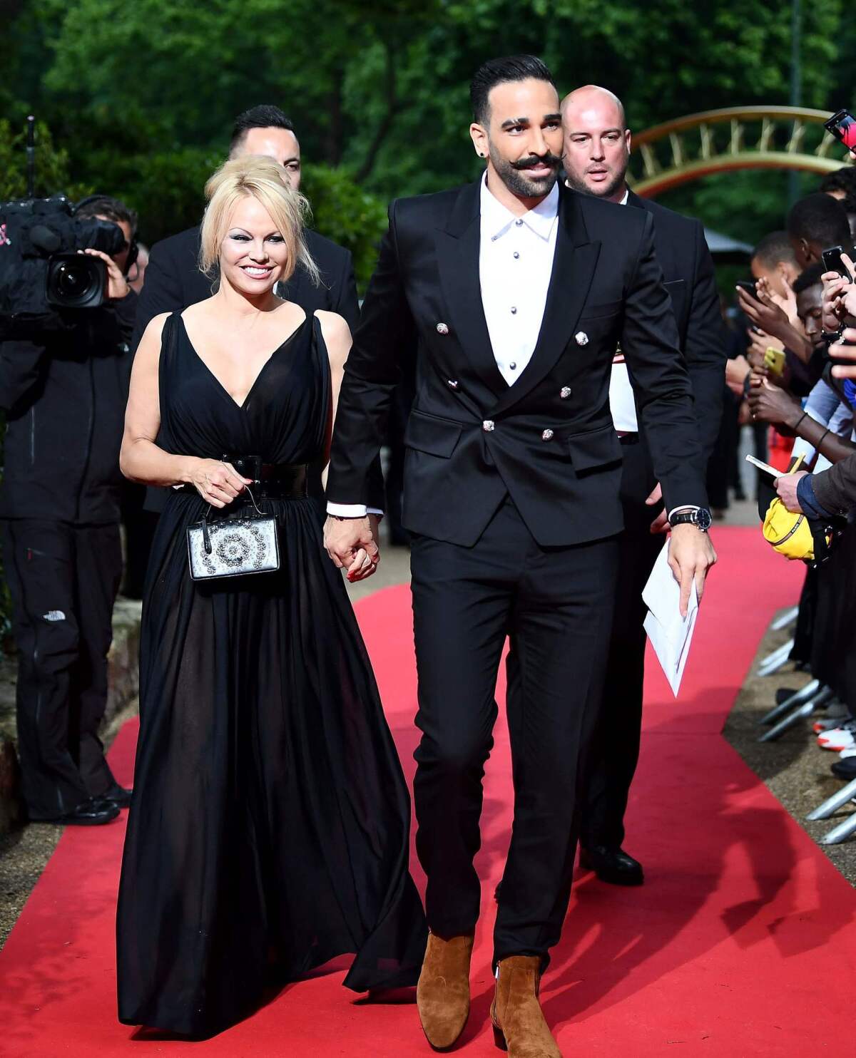 Pamela Anderson with her boyfriend, soccer player Adil Rami, arrive for a TV show taping in Paris on May 19, 2019.