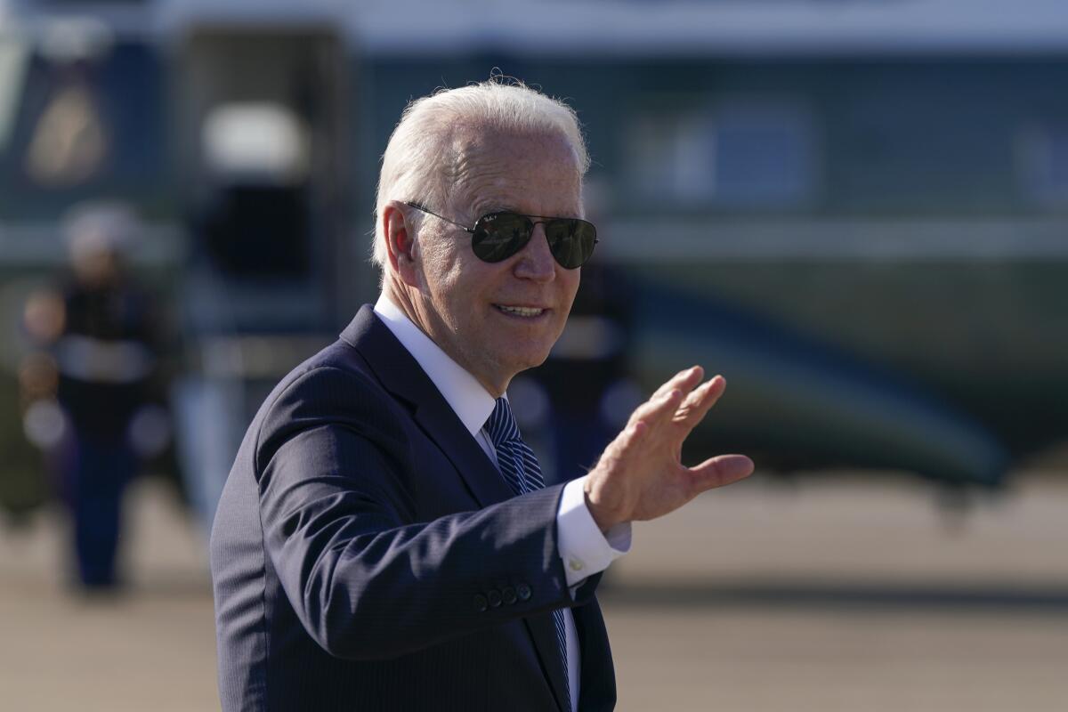 President Joe Biden waves. 