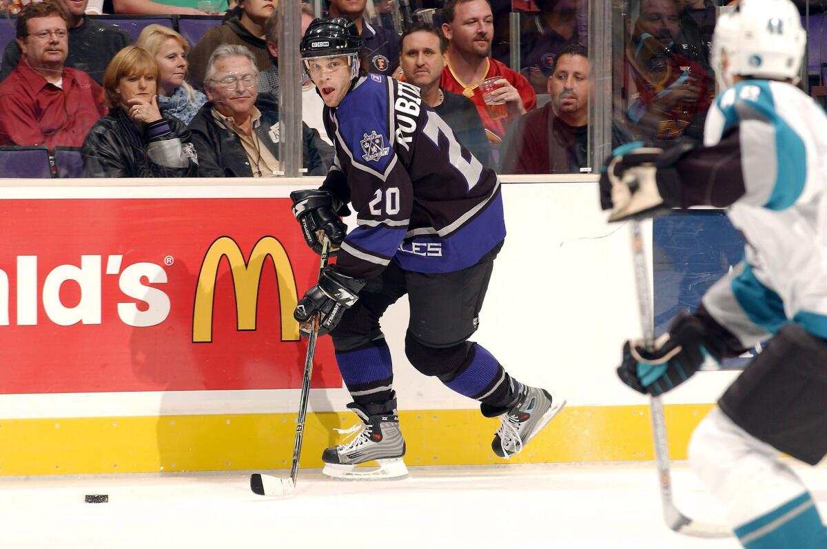 Kings forward Luc Robitaille looks for an open teammate in a 2005 preseason game against teh San Jose Sharks.