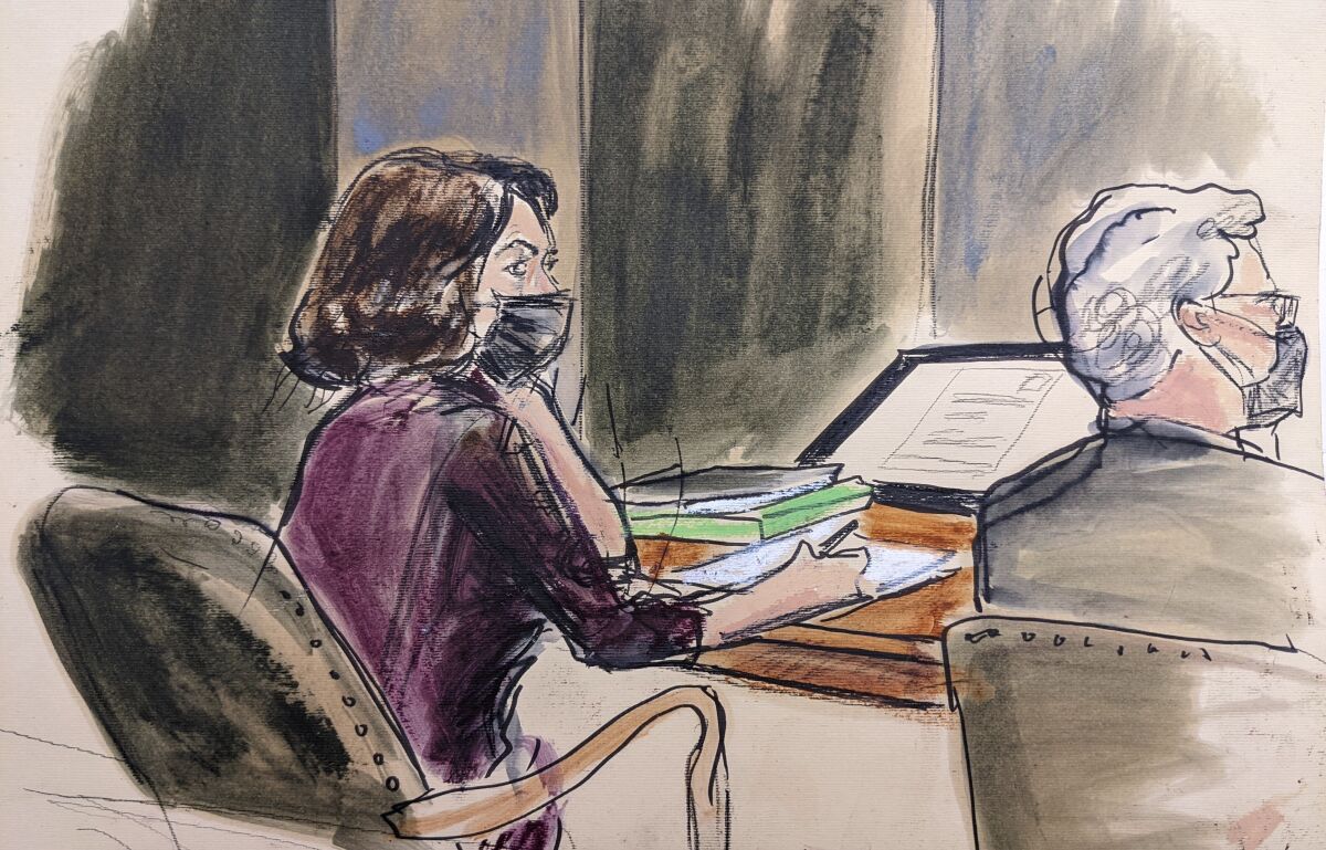 Ghislaine Maxwell sits at the defense table with an attorney