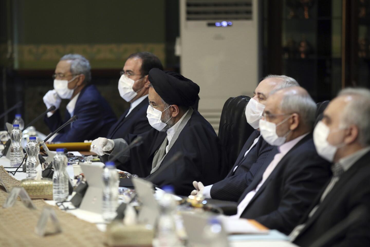 Iran: In the Office of the Iranian Presidency, Cabinet members wearing face masks and gloves attend their meeting in Tehran.