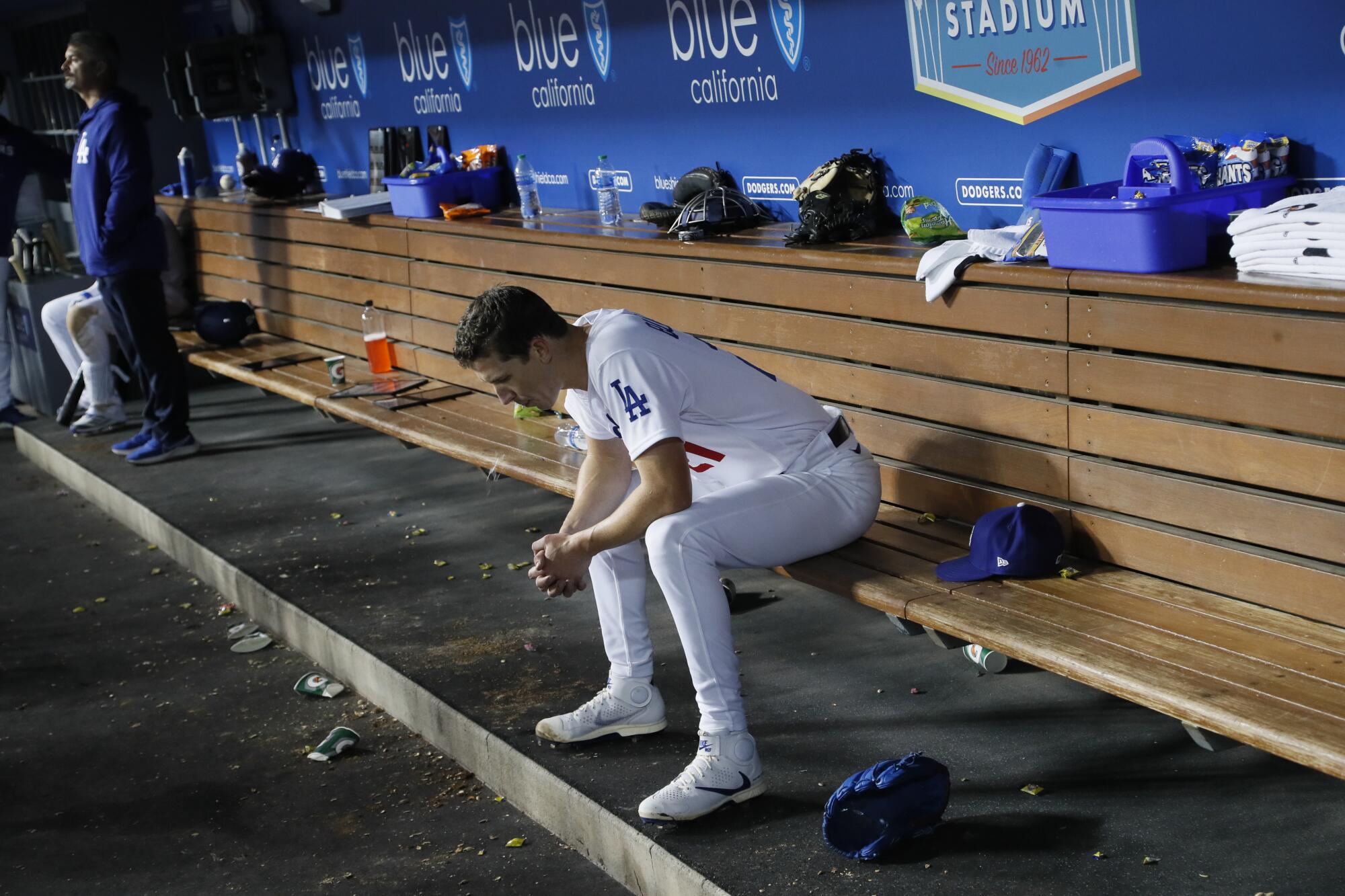 Dodgers starting pitcher Walker Buehler sits in the dugout during a game against the Cincinnati Reds in April 2022.