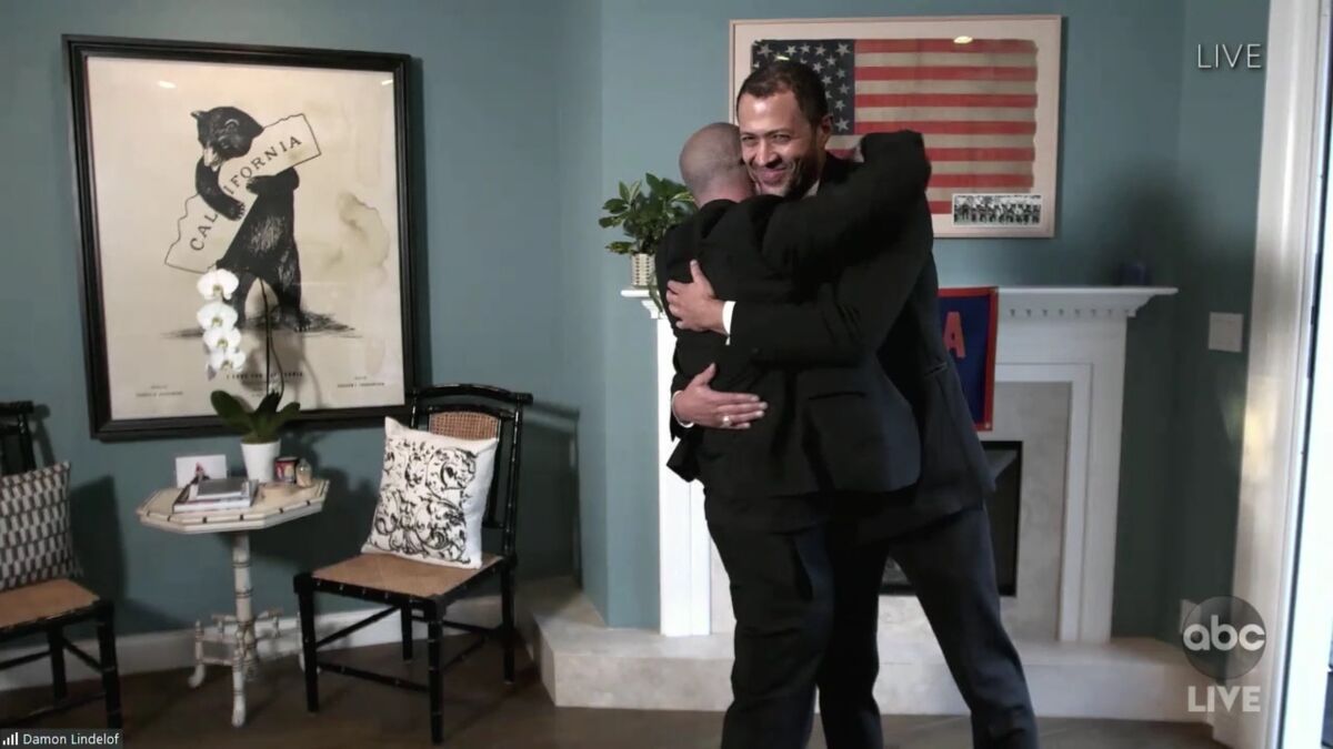 Damon Lindelof and Cord Jefferson, right, hug after winning an Emmy.