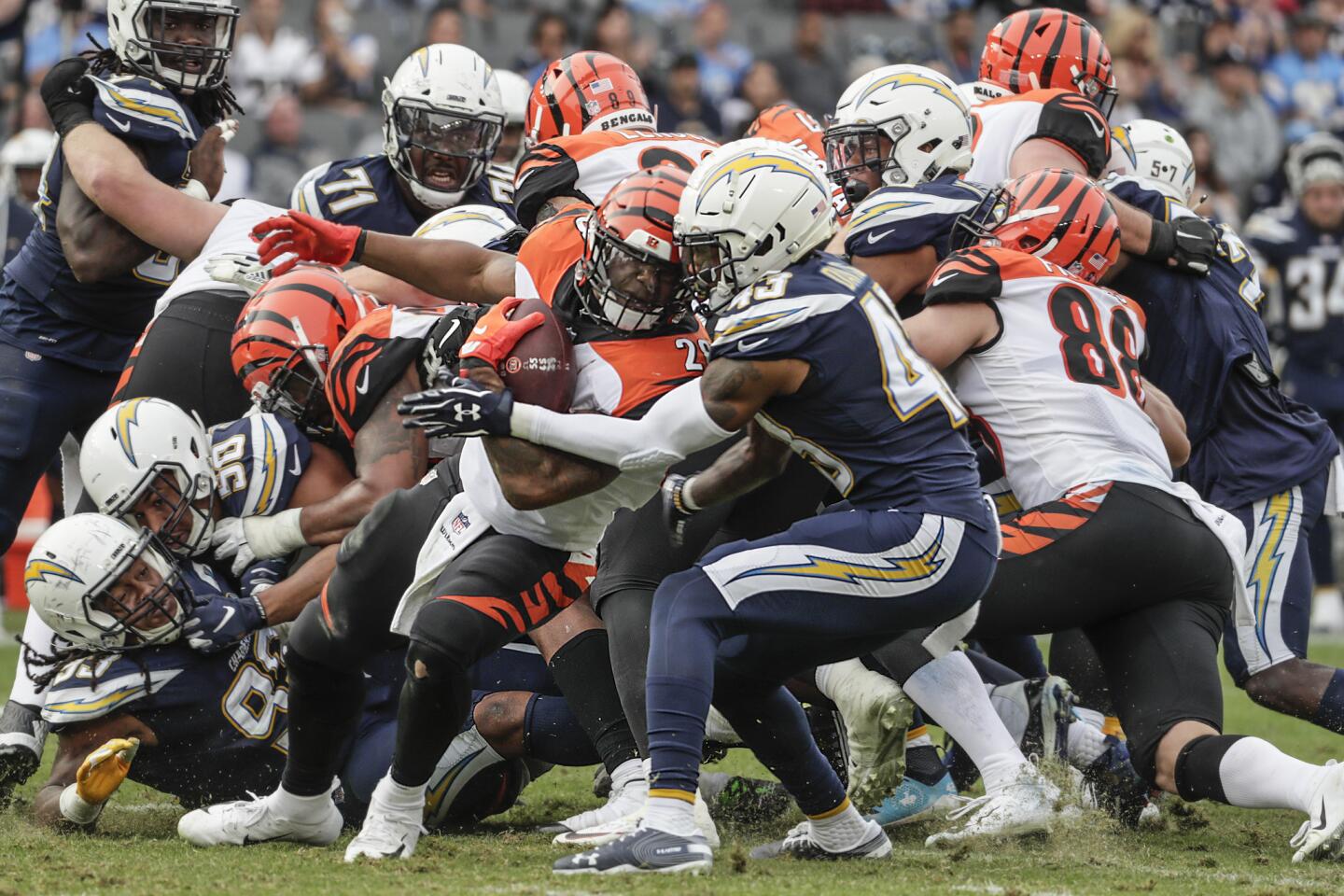 Bengals running back Joe Mixon is stopped short of a first down by Chargers cornerback Michael Davis during the secnod half.