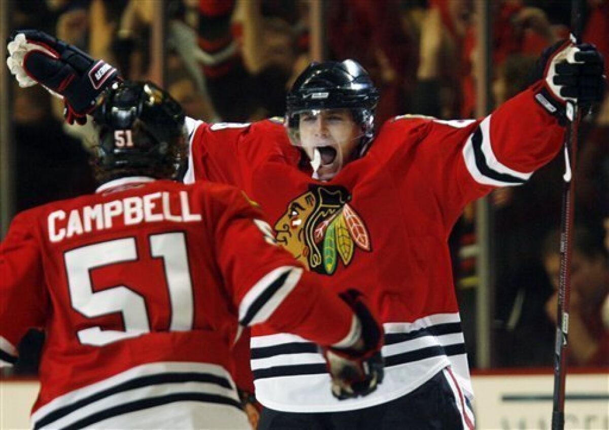 Chicago Blackhawks' Patrick Kane, right, celebrates with Brian Campbell after scoring his goal against the Vancouver Canucks during the third period of Game 6 of the NHL hockey Western Conference semifinal, Monday, May 11, 2009, in Chicago. The Blackhawks won 7-5. (AP Photo/Nam Y. Huh)
