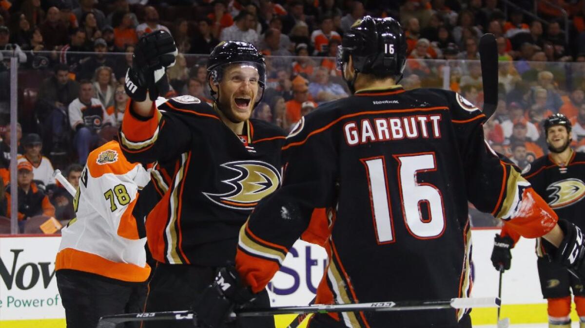 Ducks defenseman Korbinian Holzer congratulates forward Ryan Garbutt (16) on his game-winning goal in the third period of a game against the Flyers on Oct. 20.