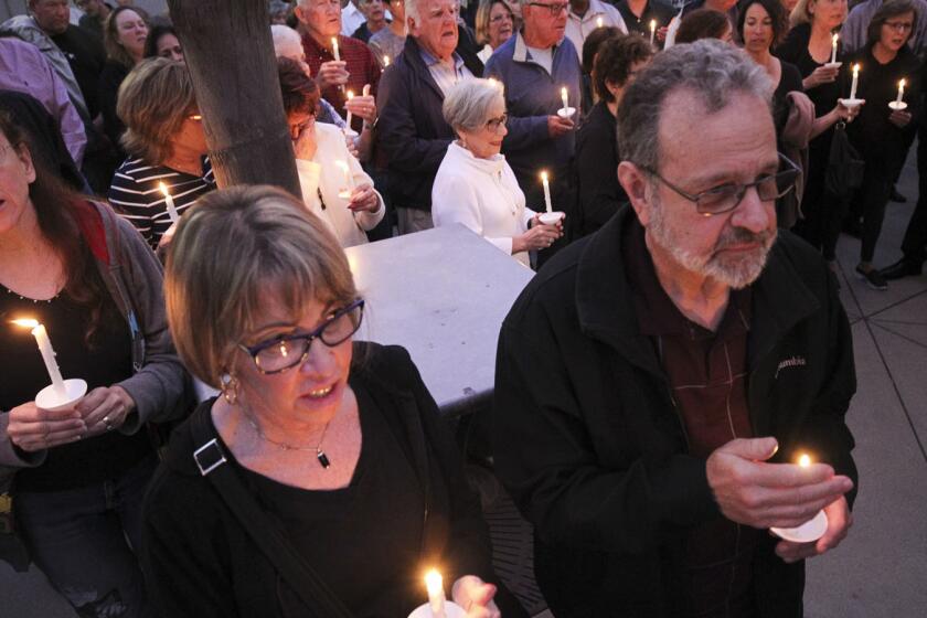 People from the community, many of them of various faiths, join members of the Rancho Bernardo Community Presbyterian Church in a candlelight vigil for the Chabad of Poway synagogue shooting victims at the Rancho Bernardo Community Presbyterian Church in the Rancho Bernardo neighborhood of San Diego, Calif., Saturday, April 27, 2019. (Hayne Palmour IV/The San Diego Union-Tribune via AP)