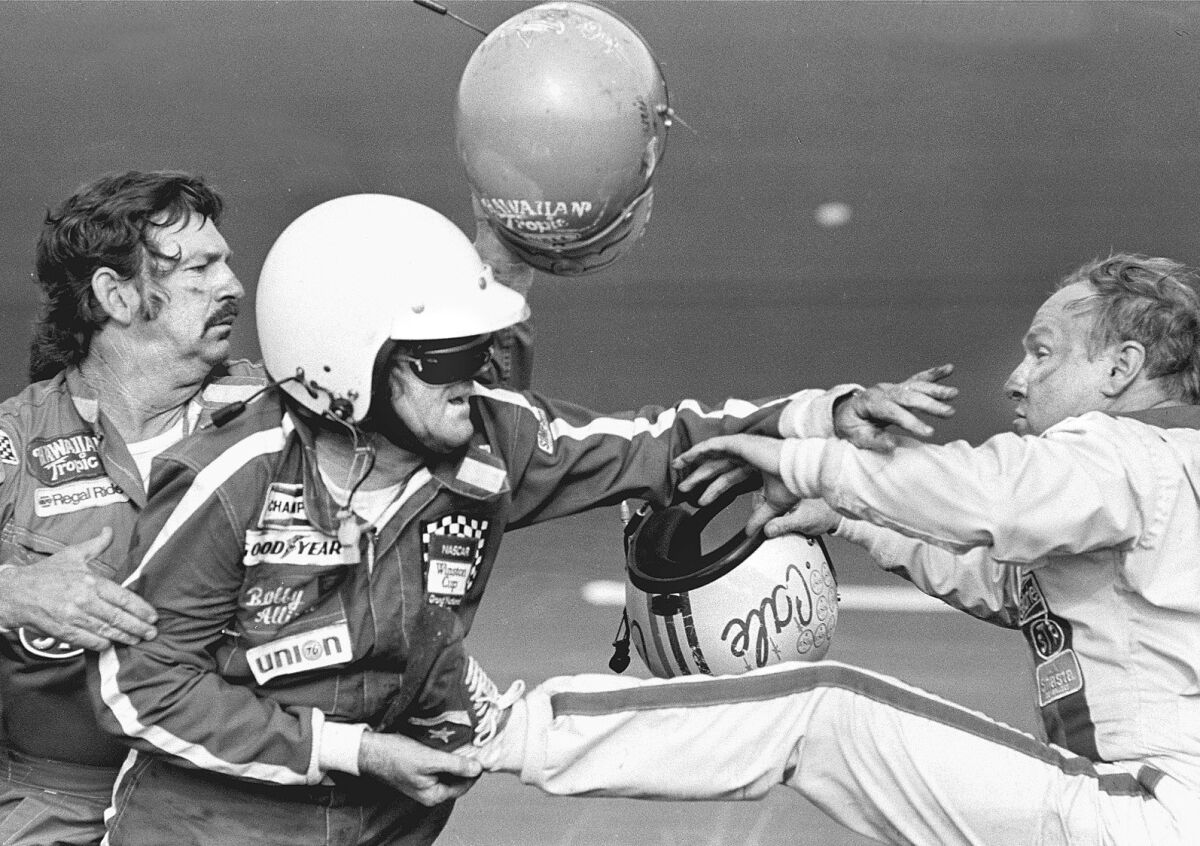 In front of brother Donnie Allison, Bobby Allison grabs the foot of Cale Yarborough, who had hit Bobby in the nose with his helmet at the Daytona 500 on Feb. 18, 1979.