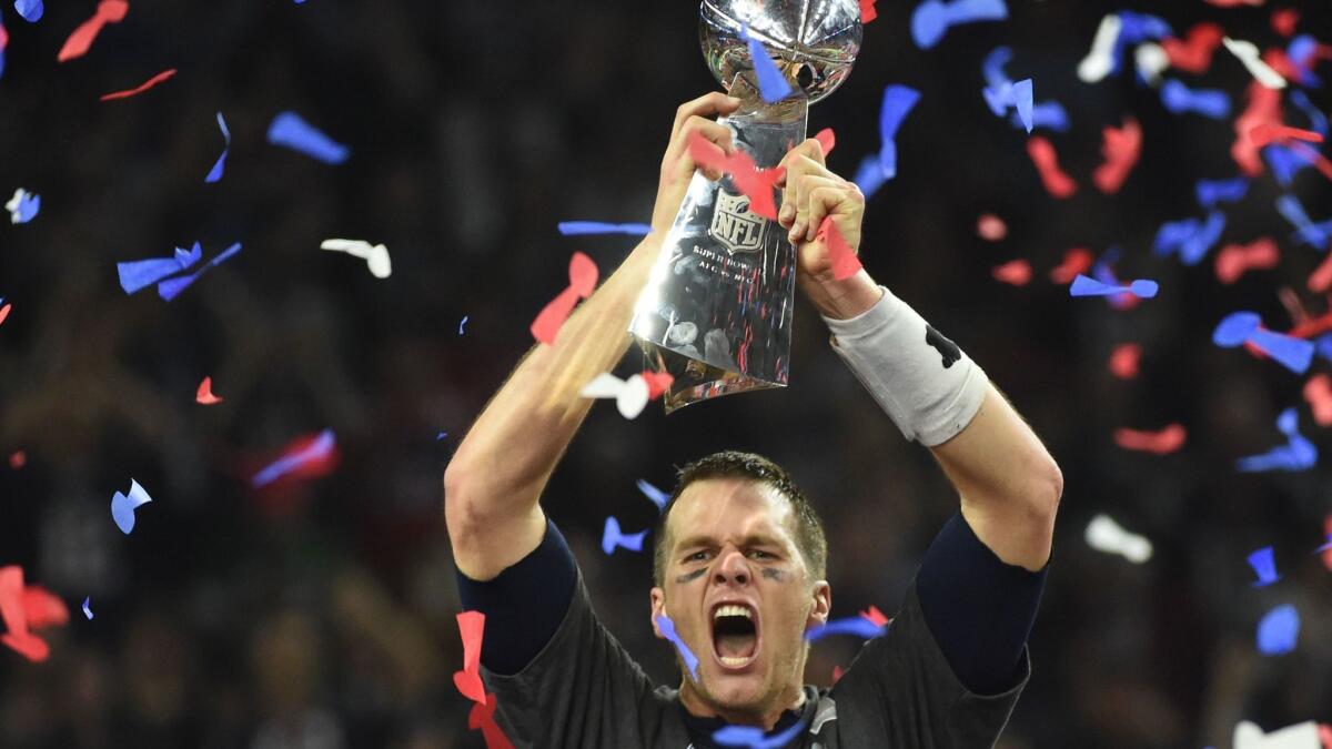 Tom Brady of the New England Patriots holds the Vince Lombardi Trophy after defeating the Atlanta Falcons 34-28 in overtime during Super Bowl 51 at NRG Stadium.