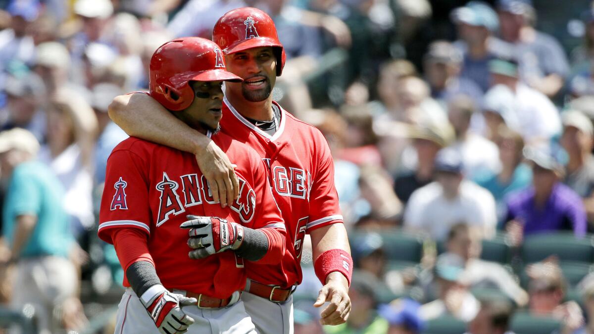 Veterans Erick Aybar, left, and Albert Pujols, have helped the Angels climb into first place in the AL West with a recent surge on a road trip before the All-Star break.