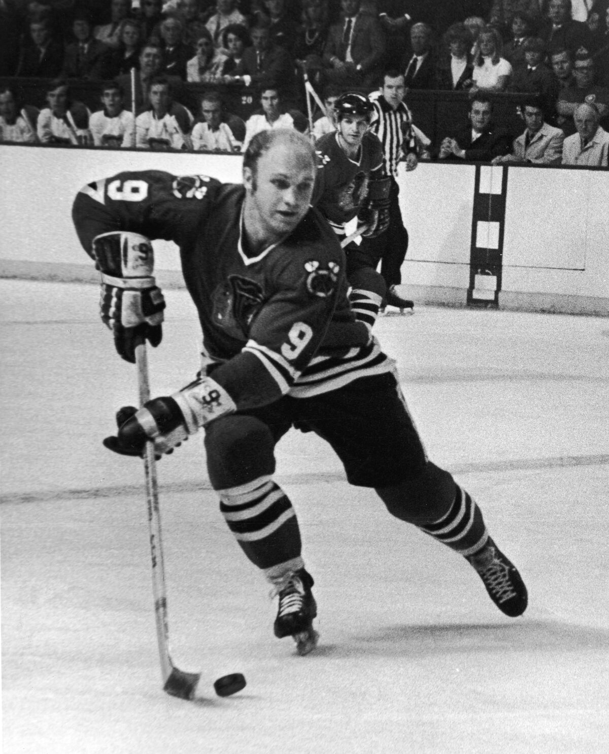 1969 photo of hockey player Bobby Hull handling the puck during a game against the Montreal Canadiens. 