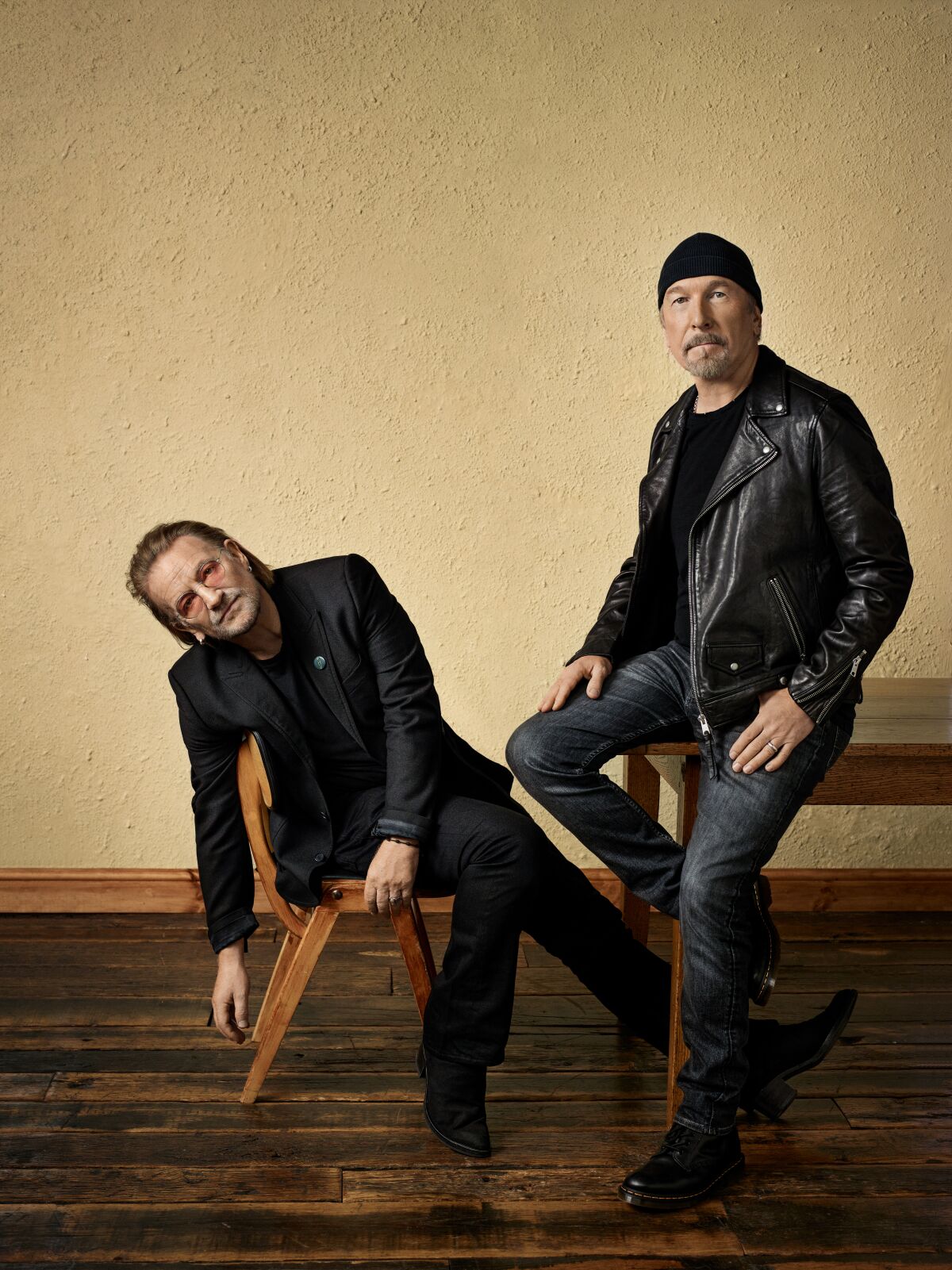 Bono in a black suit and the Edge in black leather jacket and beanie