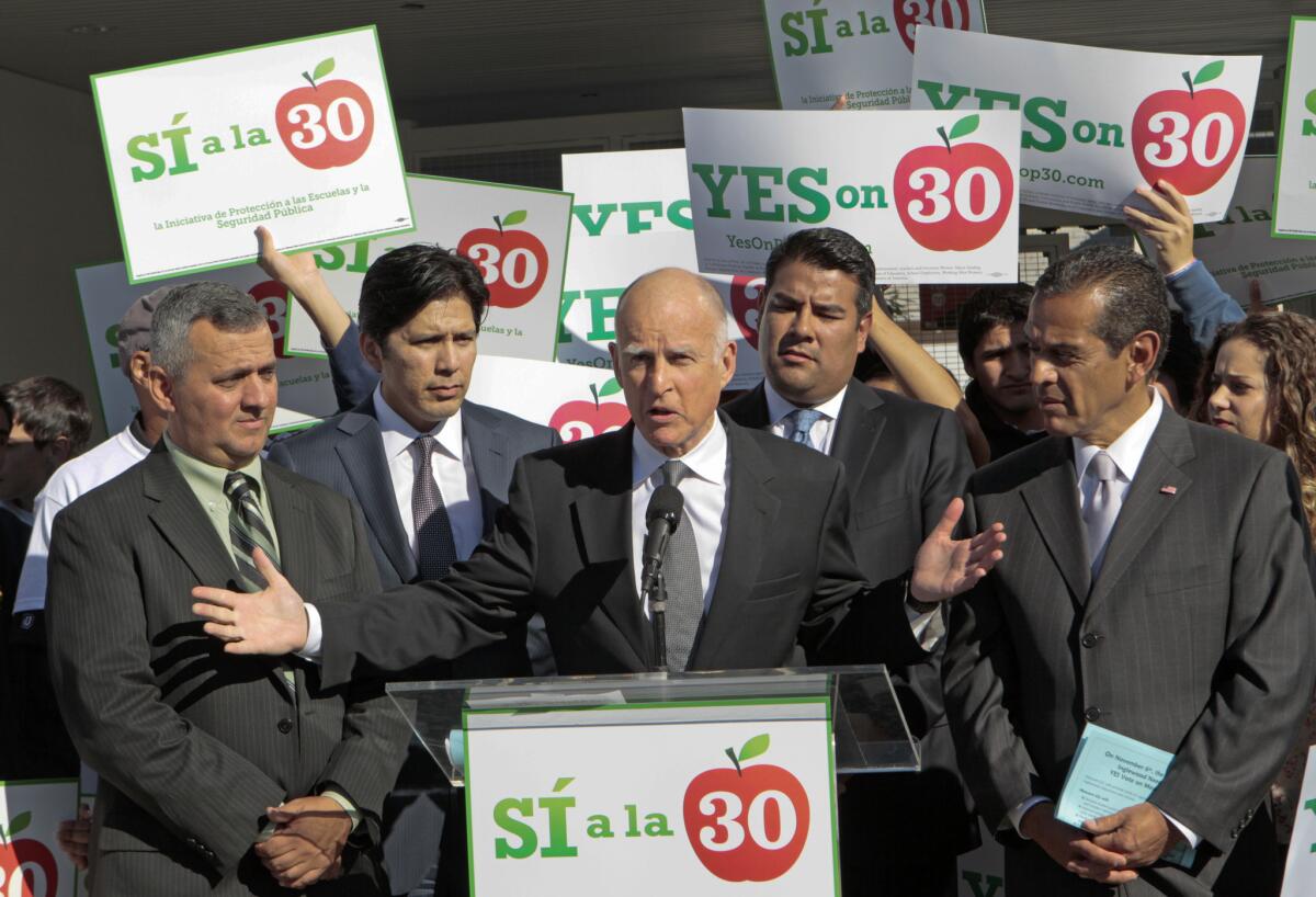 Gov. Jerry Brown campaigning to temporarily raise taxes in 2012. Although he's said the higher taxes should be allowed to expire, activist groups are pushing two different measures to extend them.