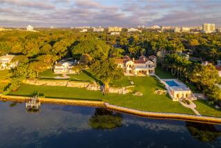 The four-acre estate includes 400 feet of water frontage and two mansions that combine for more than 20,000 square feet.