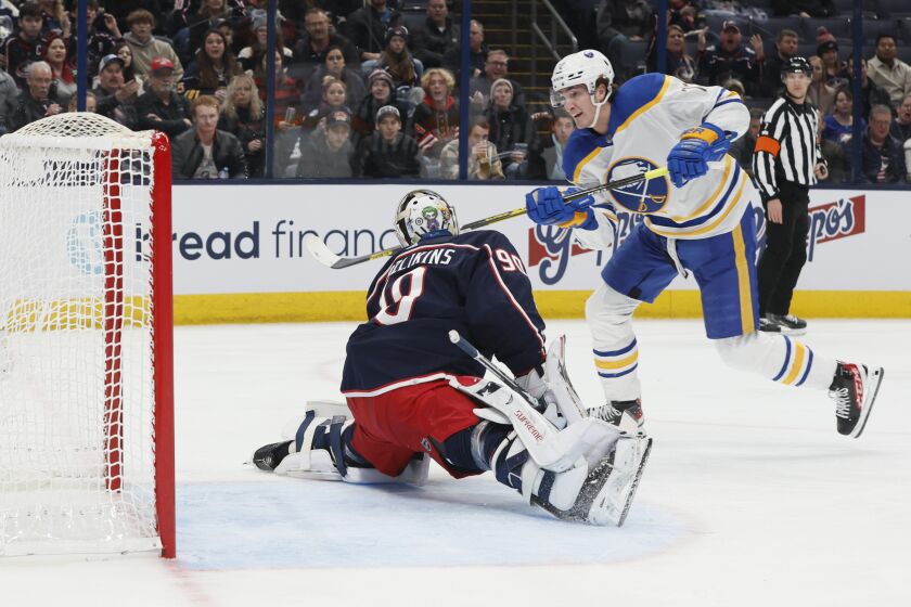Buffalo Sabres' Tage Thompson, right, scores a goal against Columbus Blue Jackets' Elvis Merzlikins during the first period of an NHL hockey game Wednesday, Dec. 7, 2022, in Columbus, Ohio. (AP Photo/Jay LaPrete)