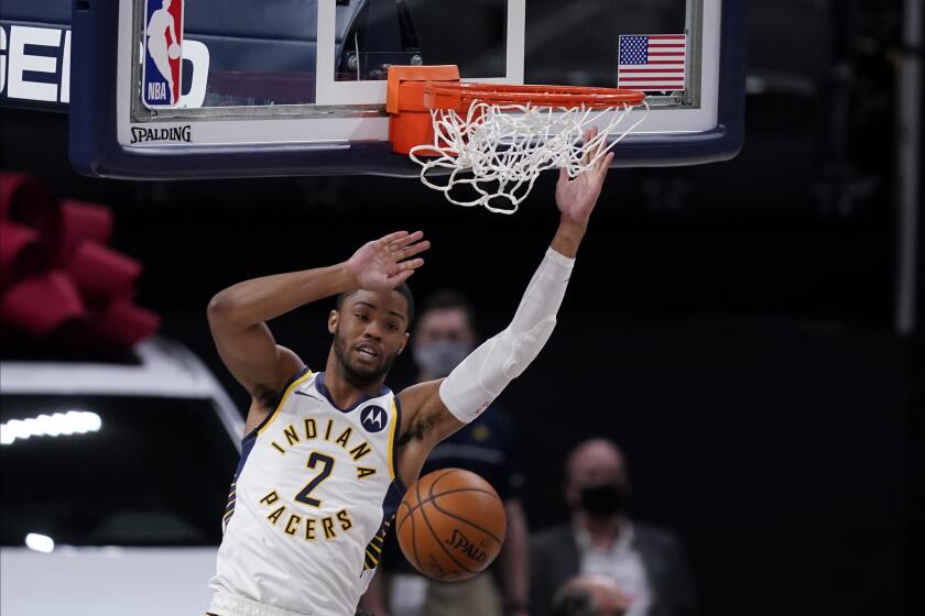 Indiana Pacers' Cassius Stanley (2) dunks during the first half of an NBA basketball game against the Philadelphia 76ers, Friday, Dec. 18, 2020, in Indianapolis. (AP Photo/Darron Cummings)