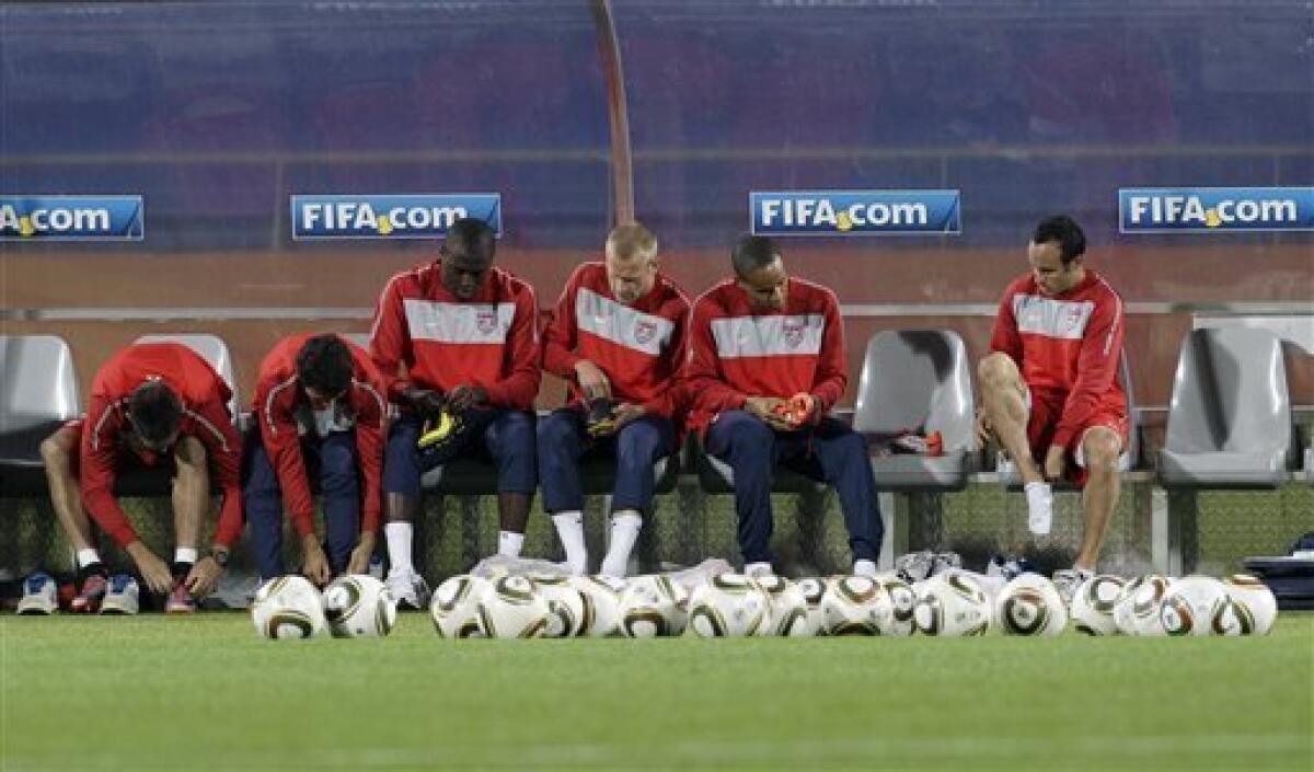 U.S. national soccer players from left, Clint Dempsey, Jonathan Bornstein, Jozy Altidore, Jay DeMerit, Ricardo Clark, and Landon Donovan put their shoes on for training at Royal Bafokeng Stadium in Rustenburg, South Africa, Friday, June 11, 2010. The U.S. will play England in a soccer World Cup Group C match on Saturday. (AP Photo/Elise Amendola)