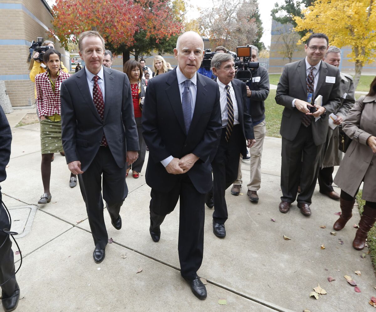 Gov. Jerry Brown, pictured here arriving at a Sacramento school last week, has played coy when asked by reporters whether he will seek an unprecedented fourth term as governor next year.
