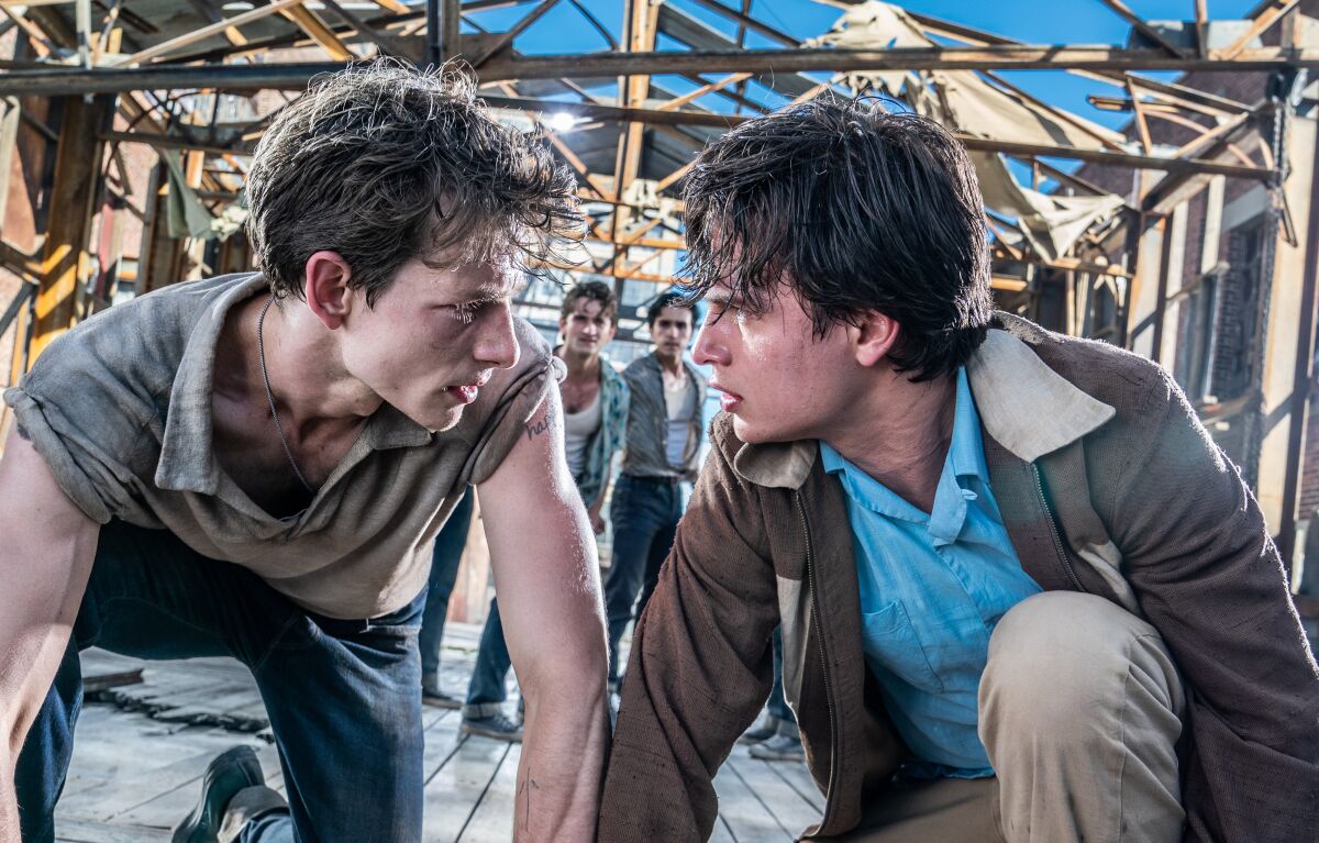 Mike Faist as Riff and Ansel Elgort as Tony crouch together during a fight in "West Side Story."