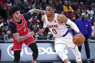 Los Angeles Lakers guard Russell Westbrook, right, drive to the basket against Chicago Bulls.