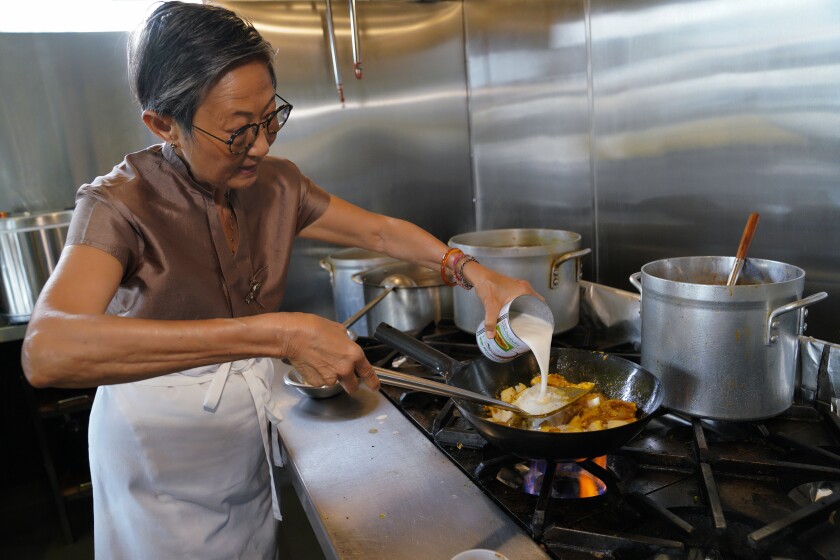 At Saffron in La Jolla, Su-Mei Yu prepares a yellow curry with chicken dish.