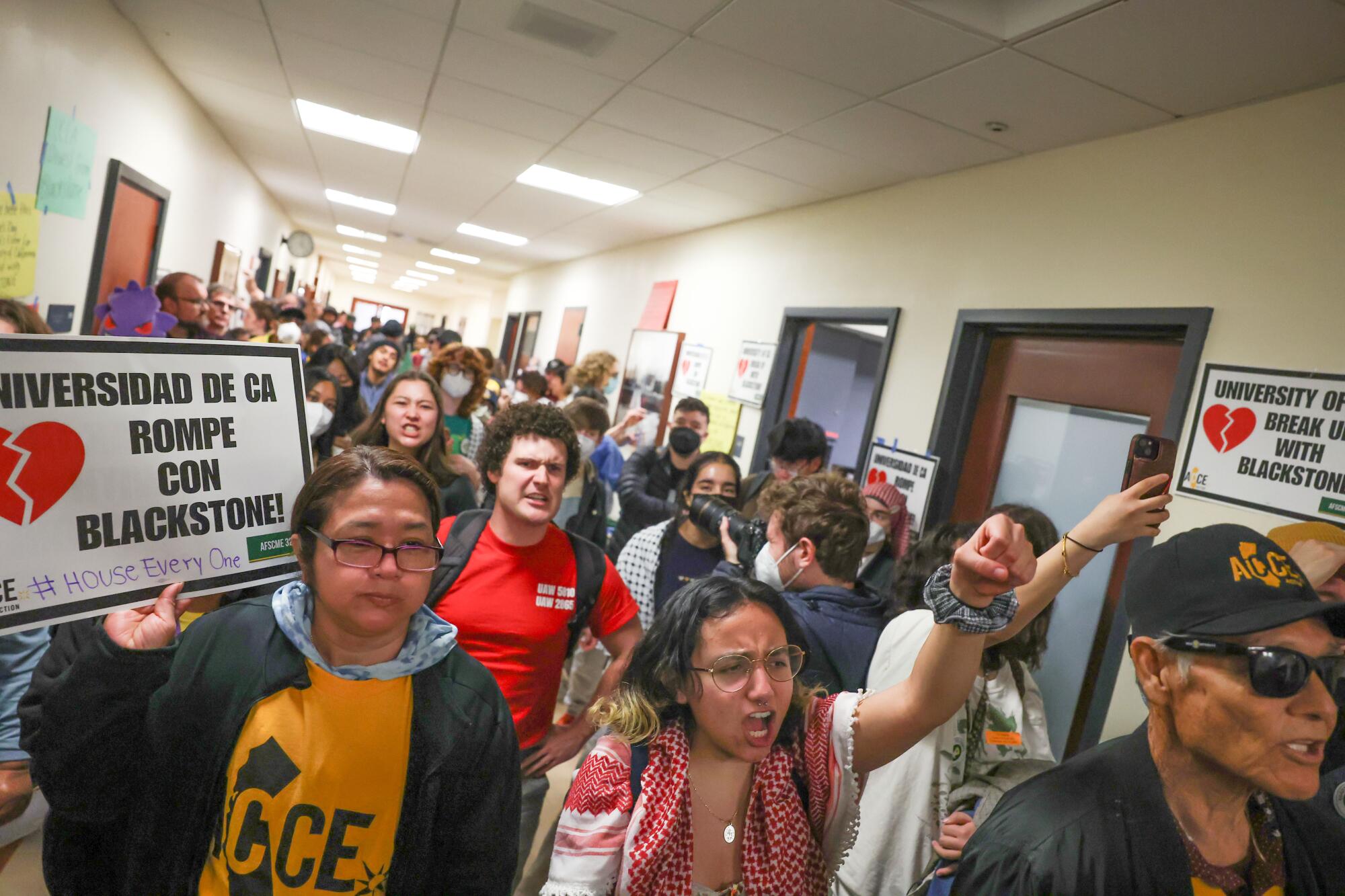 Protesters fill a corridor in a building.