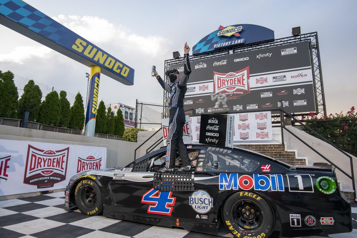 Kevin Harvick (4) celebrates after winning a NASCAR Cup Series auto race at Dover International Speedway, Sunday, Aug. 23, 2020, in Dover, Del. (AP Photo/Jason Minto)