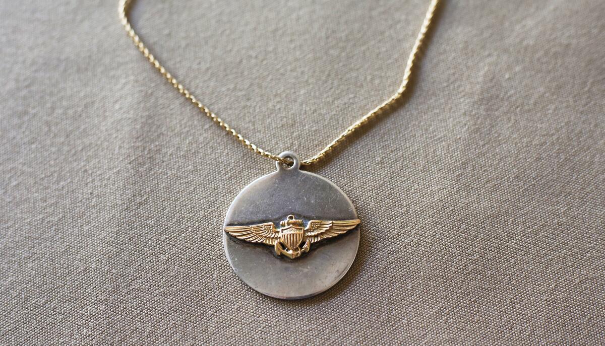 Mary Crosby, widow of downed Vietnam War Navy pilot Lt. Cmdr. Frederick Crosby, wore this pendant made from pilot's wings. The inscription on the back reads, "Wherst thou goest, so go I."