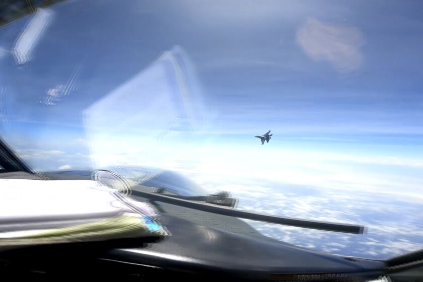 In this image from video provided by the U.S. Navy, a Chinese J-16 fighter flys aggressively close to a U.S. RC-135 aircraft flying in international airspace over the South China Sea on Friday, May 26, 2023. In a statement, U.S. Indo-Pacific Command said the Chinese J-16 fighter pilot "flew directly in front of the nose of the RC-135." It called the Chinese move an " unnecessarily aggressive maneuver." (U.S. Navy via AP)
